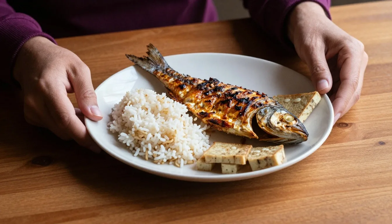 A plate of grilled fish with rice and vegetables, showing practical nutrition for men
